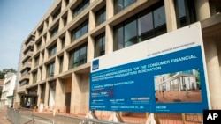 A sign stands at the construction site for the Consumer Financial Protection Bureau's new headquarters in Washington, Aug. 27, 2018. Seth Frotman, the nation's top government official overseeing the $1.5 trillion student loan market resigned Monday.