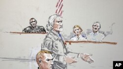 U.S. Army Staff Sgt. Calvin Gibbs, seated at lower left, is shown in this courtroom sketch as his attorney Phil Stackhouse stands at center, and military Judge Lt. Col. Kwasi Hawks listens, at top left, October 31, 2011, at Joint Base Lewis-McChord in Was