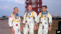 In this undated photo made available by NASA, (L-R) veteran astronaut Virgil Grissom, first American spacewalker Ed White and rookie Roger Chaffee, stand for a photograph in Cape Kennedy, Fla. 