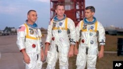 In this undated photo made available by NASA, (L-R), veteran astronaut Virgil Grissom, first American spacewalker Ed White and rookie Roger Chaffee, stand for a photograph in Cape Kennedy, Florida, today Cape Canaveral. 