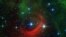 The red arc in this infrared image from NASA's Spitzer Space Telescope is a giant shock wave, created by a speeding star known as Kappa Cassiopeiae. It is a massive, hot supergiant moving at around 2.5 million mph relative to its neighbors (1,100 kilometers per second). But what really makes the star stand out is the surrounding, streaky red glow of material called a bow shock, in its path. (Image Credit: NASA/JPL-Caltech)