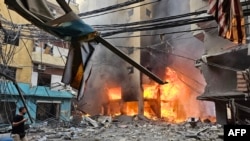 A fire rages inside a building hit by an Israeli airstrike that targeted the neighborhood of Haret Hreik in Beirut&#39;s southern suburbs, Lebanon.