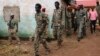 FILE -South Sudanese soldiers accused of a horrific attack on foreign aid workers including rape, torture, killing and looting on the Terrain hotel compound, are assisted to a prison van after attending their trial in Juba, South Sudan.