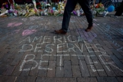 A man walks past a memorial for those killed in a mass shooting in Dayton, Ohio, Aug. 7, 2019.