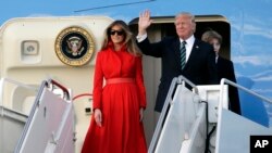 President Donald Trump waves from Air Force One with First Lady Melania and son Barron after arriving at Palm Beach International Airport, March 17, 2017, in West Palm Beach, Florida, to spend the weekend at his Mar-a-Lago Estate in Palm Beach.