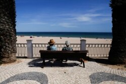 People look at Luz beach on the first day that Britons are allowed to enter Portugal without needing to quarantine, as COVID-19 restrictions continue to ease, in Lagos, Portugal, May 17, 2021.