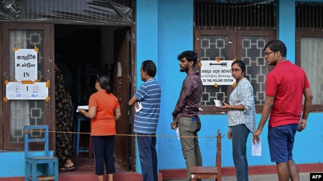 People queue at a polling station before casting their ballots to vote in Sri Lanka's parliamentary election in Colombo on Nov.r 14, 2024.