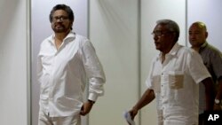 FILE - Ivan Marquez, chief negotiator for the Revolutionary Armed Forces of Colombia, or FARC, left, is seen arriving for a new round of peace talks with Colombia's government in Havana, Cuba, June 17, 2015.