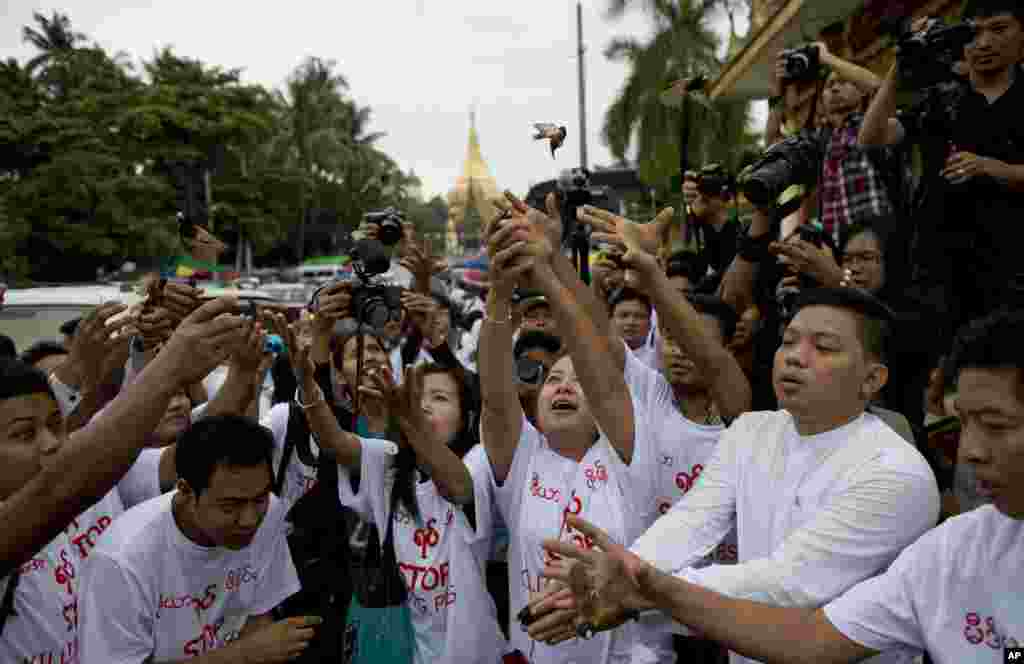 Myanmar (also known as Burma) journalists release imprisoned birds after a prayer session in Yangon in support of four reporters and the chief executive of the Yangon-based &quot;Unity Journal.&quot; The journalists were sentenced Thursday to 10 years of hard prison labor for violating national security by writing and publishing stories about a weapons factory.