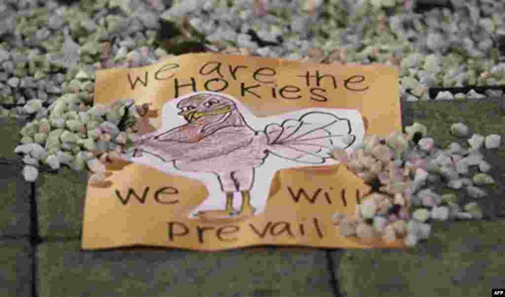 A sign placed by a student rests on the memorial for the 2007 shootings during a vigil on the campus of Virginia Tech after two shootings on the campus in Blacksburg, Va., Thursday, Dec. 8, 2011. A gunman killed a police officer and then apparently shot