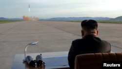 Pemimpin Korea Utara Kim Jong Un menyaksikan peluncuran rudal Hwasong-12 missile dalam foto yang tidak diketahui tanggalnya dan dirilis oleh kantor berita Korea Utara, Korean Central News Agency, 16 September 2017.