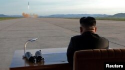 FILE - North Korean leader Kim Jong Un watches the launch of a Hwasong-12 missile in this undated photo released by North Korea's Korean Central News Agency, Sept. 16, 2017.