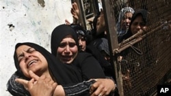 Palestinian relatives react during the funeral of a Islamic Jihad militant killed in an Israeli air strike, in Khan Younis, southern Gaza Strip, March 30, 2011