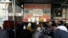 People queue for subsidized bread at a bakery equipped with a smart card system in Suez Canal city of Port Said, February 24, 2014. (Mohamed Abd El Ghany/Reuters)