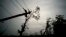 FILE - In this Oct. 16, 2017 file photo, power lines lay broken after the passage of Hurricane Maria in Dorado, Puerto Rico. Federal officials said on Jan. 8 2018, that efforts to fully restore power to Puerto Rico should get a boost with more work crews and more equipment arriving in upcoming weeks. 