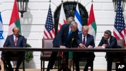 FILE - Bahrain Foreign Minister Khalid bin Ahmed Al Khalifa, left, Israeli Prime Minister Benjamin Netanyahu, President Donald Trump, and UAE Foreign Minister Abdullah bin Zayed al-Nahyan at the signing ceremony of the Abraham Accords at the White House, Sept. 15, 2020.