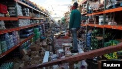 A man stands inside a supermarket destroyed by Hurricane Maria in Salinas, Puerto Rico, Sept. 29, 2017 