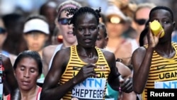 FILE - Rebecca Cheptegei of Uganda competes in the women's marathon final during the World Athletics Championship in Budapest, Hungary, Aug. 26, 2023. 