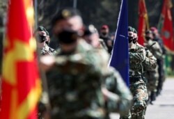 FILE - Macedonian Army special forces participate in an exercise to mark one year of NATO membership, at the army barracks in Skopje, in North Macedonia, March 27, 2021.