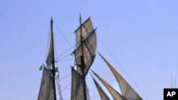 A replica of the Amistad sails past Manhattan in New York Harbor.