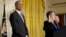 President Barack Obama listens as Homeland Security Secretary Janet Napolitano delivers the oath of allegiance during a naturalization ceremony for active duty service members and civilians, in the East Room of the White House in Washington, March 25, 20
