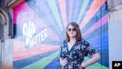 In this photo provided by the ACLU of Virginia, Ellenor Zinski stands for a portrait in front of a “You Matter” mural near the entrance to Blackwater Creek Trail, one of her favorite hiking trails in Lynchburg, Va., on Oct. 5, 2024.