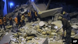 Rescuers search for survivors in the rubble of a collapsed hotel in Van, eastern Turkey, late Wednesday, Nov. 9, 2011.