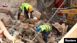 Volunteers dig through the rubble of collapsed buildings after signs of life were detected in a neighborhood of Beirut, Lebanon, Sept. 5, 2020, devastated by a massive blast Aug. 4, 2020.