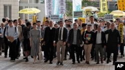 Occupy Central leaders from right; Shiu Ka Chun, Lee Wing Tat, Raphael Wong, Benny Tai, Chan Kin-man, Chu Yiu-ming, Tanya Chan, Eason Chung and Tommy Cheung arrive a court in Hong Kong, April 9, 2019. 