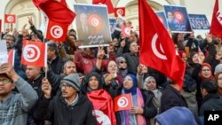 FILE: People take part in a protest against president Kais Saied policies, in Tunis, Tunisia, Sunday, March 5, 2023. Thousands of people marched through Tunisia's capital Saturday, decrying an expanding crackdown on opposition voices.