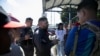 FILE - Costa Rican migration police officers speak with Venezuelan migrants at the Costa Rica- Panama border in Paso Canoas, Costa Rica, Feb. 12, 2025. 