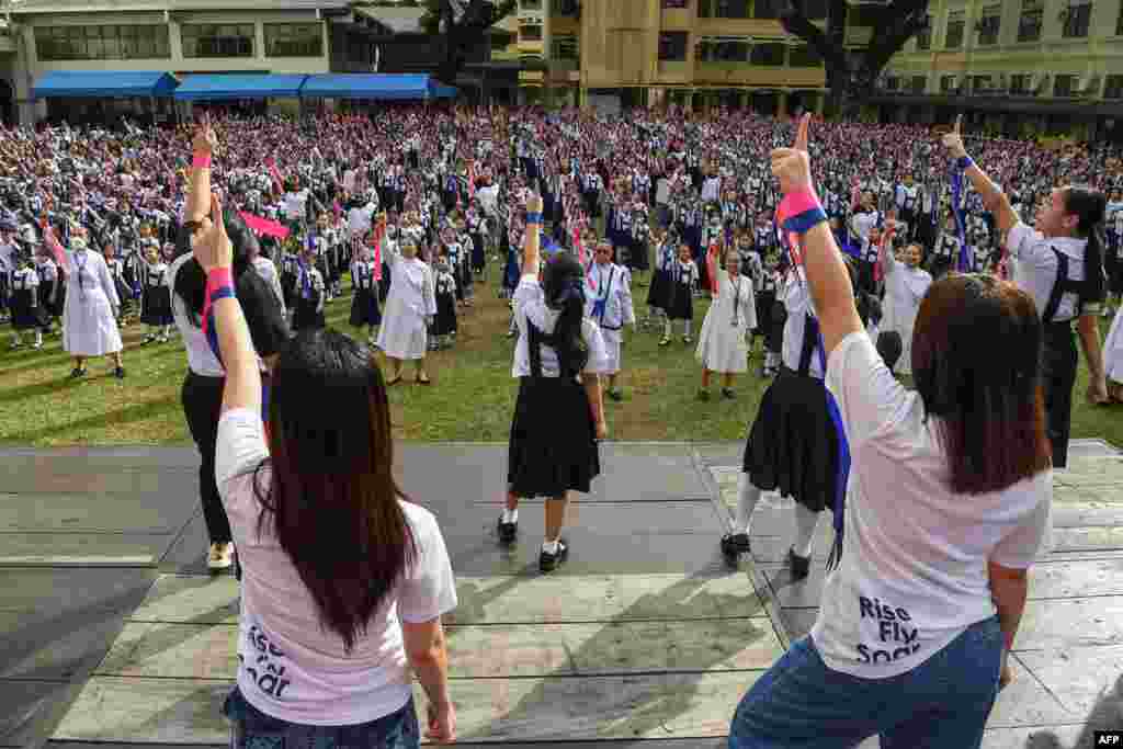 Students and nuns dance during global action on violence against women and children dubbed One Billion Rising, to coincide with Valentine&#39;s Day, at St. Scholastica&#39;s College in Manila.