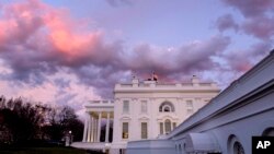 FILE - The White House is seen at sunset in Washington, Jan. 26, 2024. President Joe Biden plans to welcome Kenyan President William Ruto to the White House in May, hosting a state visit after reneging on his promise to visit Africa last year. 