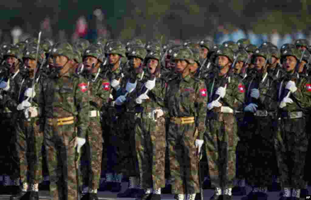 Myanmar army officers command as they participate in a ceremony to mark Myanmar's 67th anniversary of Independence Day in Naypyitaw, Myanmar, Sunday, Jan. 4, 2015. (AP Photo/Gemunu Amarasinghe)