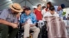 Pearl Harbor survivors, Ken Stevens, 102, of Powers, Ore., second from the left, and Ira 'Ike' Schab, 104, of Beaverton, Ore., wait before the start of the 83rd Pearl Harbor Remembrance Day ceremony, Dec. 7, 2024, in Honolulu. 