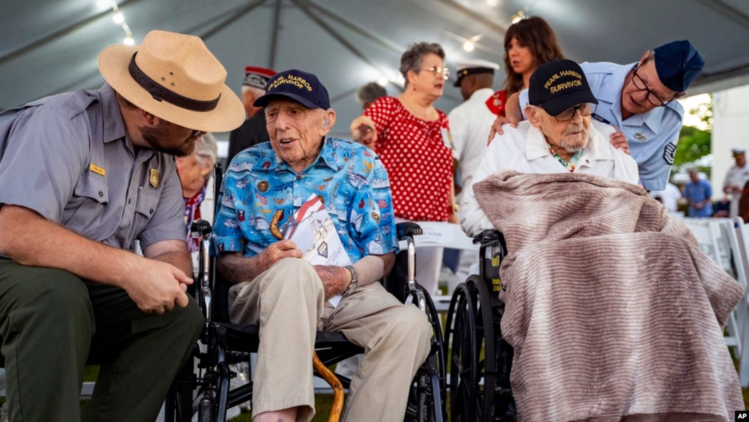 Pearl Harbor survivors, Ken Stevens, 102, of Powers, Ore., second from the left, and Ira 'Ike' Schab, 104, of Beaverton, Ore., wait before the start of the 83rd Pearl Harbor Remembrance Day ceremony, Dec. 7, 2024, in Honolulu. 
