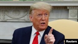 FILE - President Donald Trump speaks in the Oval Office of the White House, in Washington, Feb. 12, 2020.