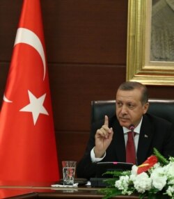 FILE - Turkish Prime Minister Recep Tayyip Erdogan speaks to the media in his office in Ankara, April 23, 2014.
