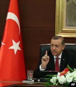 FILE - Turkish Prime Minister Recep Tayyip Erdogan speaks to the media in his office in Ankara, April 23, 2014.