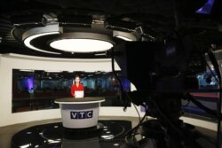 FILE - Vietnamese television anchor Hoang Phuong works in a studio of VTC Television during a news program in Hanoi, Vietmam, May 2, 2018.