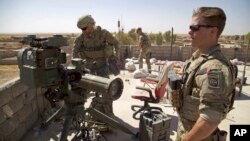 FILE - U.S. Army soldiers stand next to a guided-missile launcher, a few miles from the front line, in the village of Abu Ghaddur, east of Tal Afar, Iraq, Aug. 20, 2017.