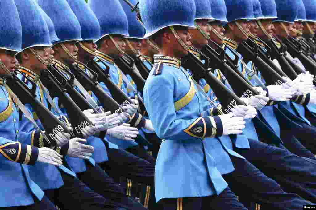 Thai Royal Guards march in front of the Grand Palace, during a military parade as a part of a celebration for the upcoming birthday of Thailand&#39;s King Bhumibol Adulyadej, in Bangkok. The revered King will turn 87-years-old on Dec. 5.