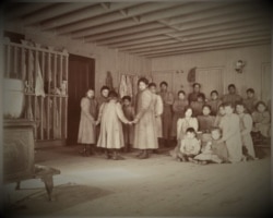 Children posed in an unknown Indian boarding school in Minnesota, ca. 1900.