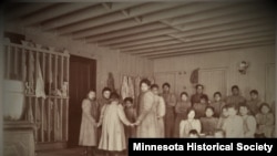 FILE - Children pose in an unidentified Indian boarding school in Minnesota, ca. 1900. 