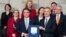 NATO Secretary General Jens Stoltenberg, 3rd right, and Macedonia's Foreign Minister Nikola Dimitrov, 3rd left, pose for photographers with NATO permanent representatives after they signed the "accession protocol" at NATO headquarters in Brussels, Feb. 6, 2019. 