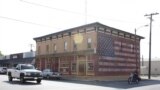 A Main Street building with an American flag painted on its side, Plano, Illinois. (K. Farabaugh/VOA)