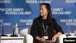 FILE - Meng Wanzhou, chief financial officer of Chinese technology giant Huawei, attends a session of the VTB Capital Investment Forum "Russia Calling!" in Moscow, Russia Oct. 2, 2014. 