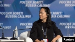 FILE - Meng Wanzhou, executive board director of the Chinese technology giant Huawei, attends a session of the VTB Capital Investment Forum "Russia Calling!" in Moscow, Russia Oct. 2, 2014. 