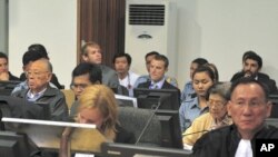 Former Khmer Rouge foreign minister Ieng Sary (2nd row from front, L) and former social affairs minister Ieng Thirith (2nd row from front, 2nd R) sit at the Extraordinary Chambers in the Courts of Cambodia (ECCC) on the outskirts of Phnom Penh June 27, 20