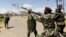 FILE - A riot policeman fires a teargas canister to disperse demonstrators during protests in Narok, Kenya, January 26, 2015.